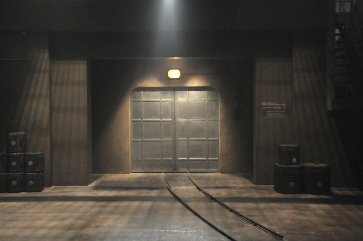 A dark room with metal doors